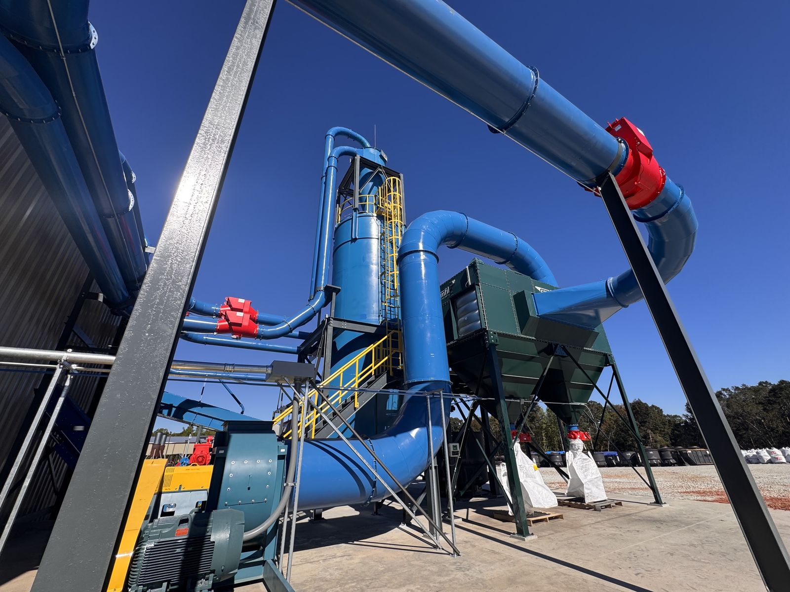Blue cyclone tower and ductwork outside at the Georgia Wood Char site in Commerce, Georgia